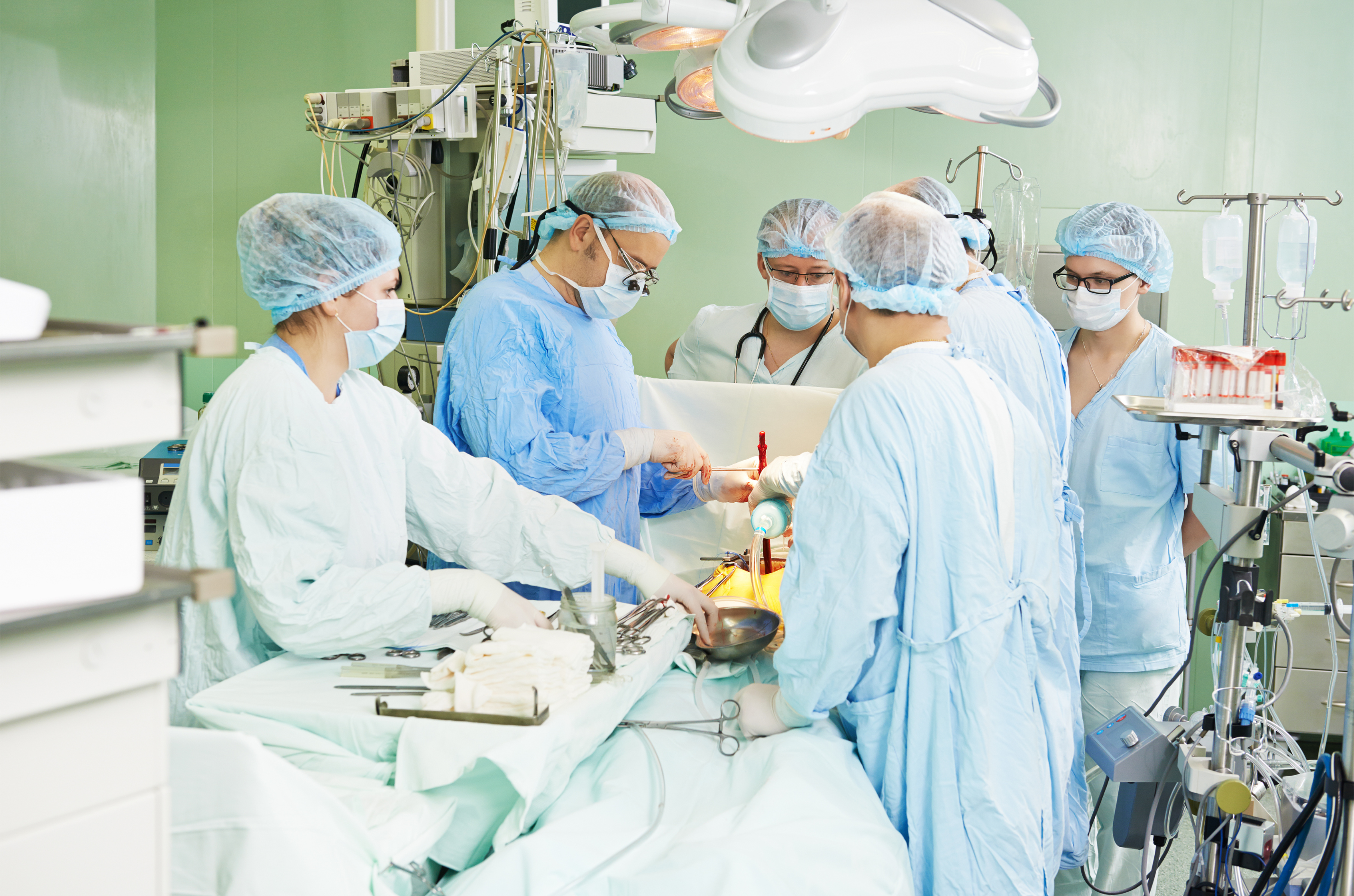 Team of heart specialists reviewing patient charts in a hospital setting