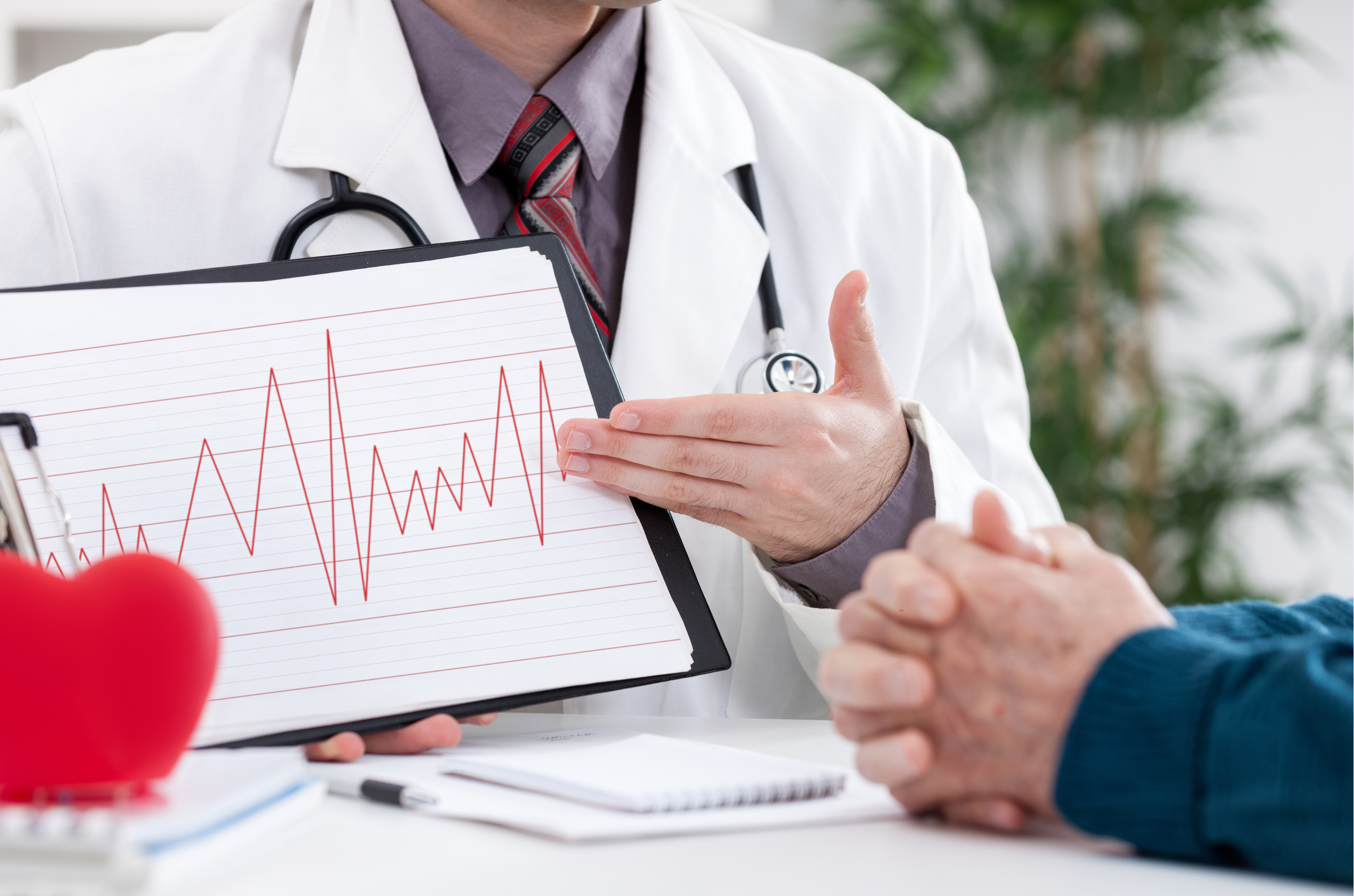 Close-up of ECG monitor showing heartbeat rhythm during consultation