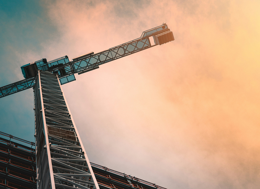 Contractor reviewing project performance metrics and construction trends