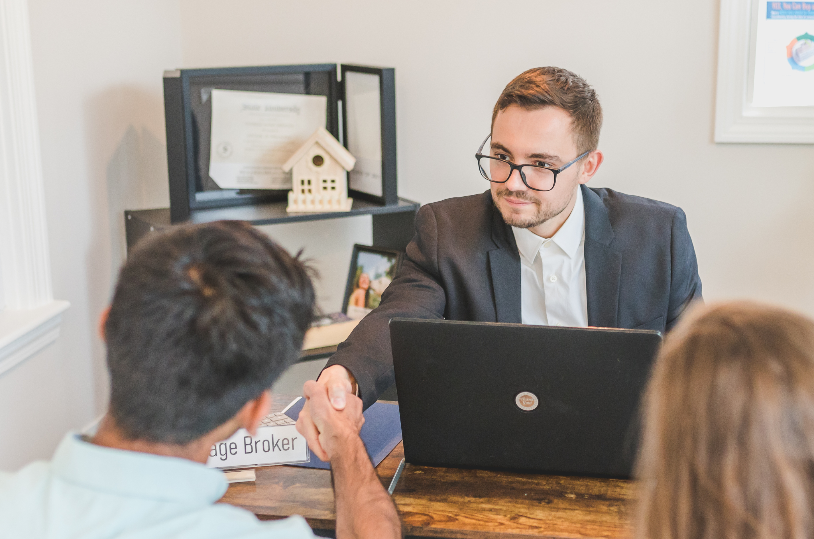 Mortgage specialist advising a client on home loan options in a professional setting